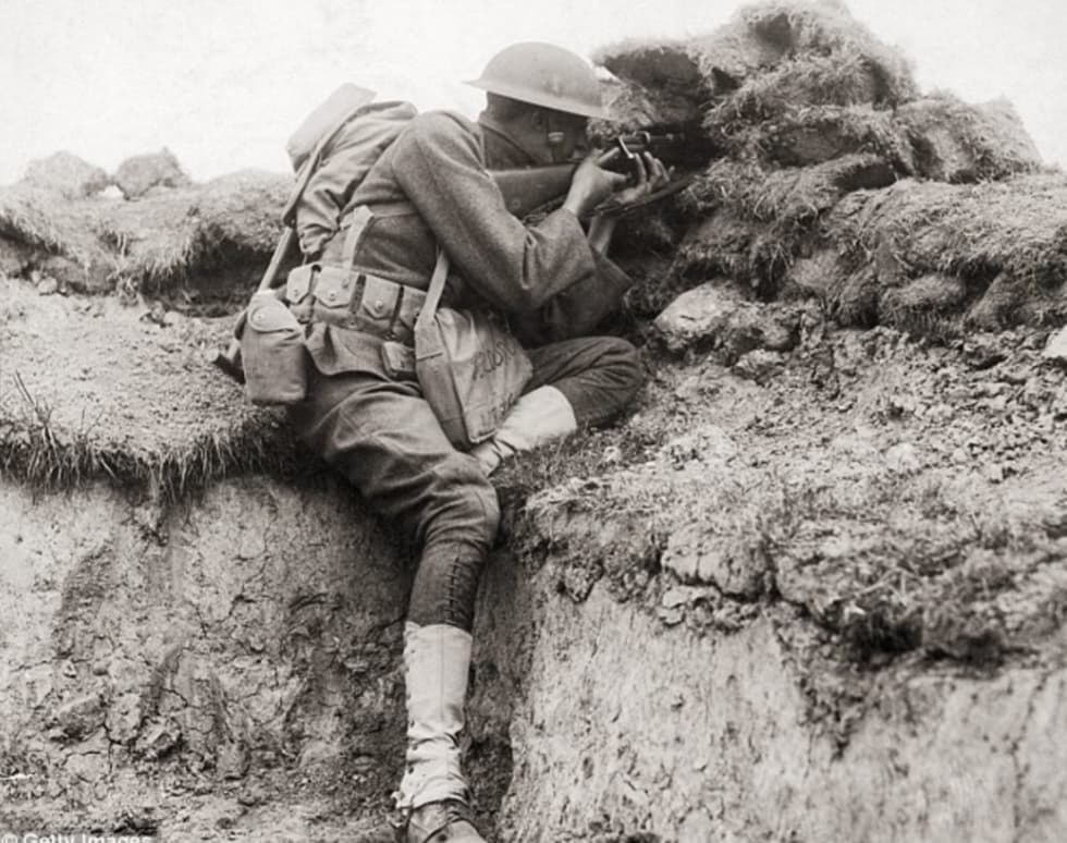 “An American sniper takes aim at the Germans from the trenches in France during World War I, c. 1918.”